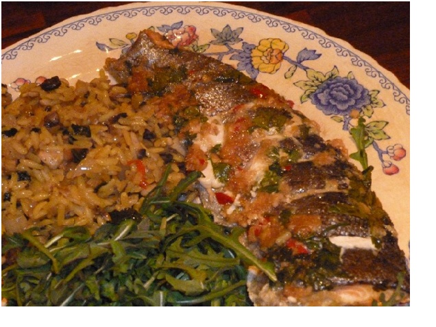 Rainbow trout fillets fried with tomatoes and capers